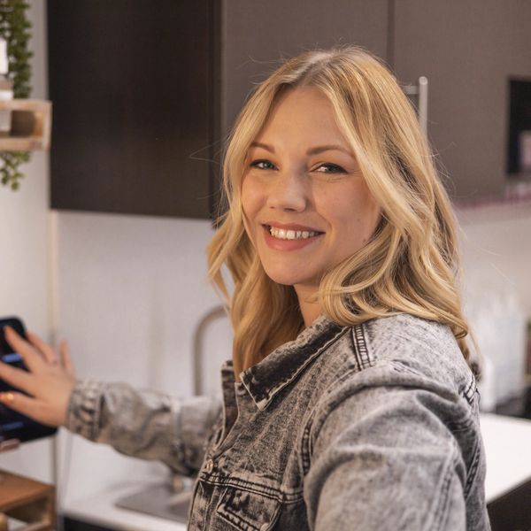Smiling hair stylist in salon studio 