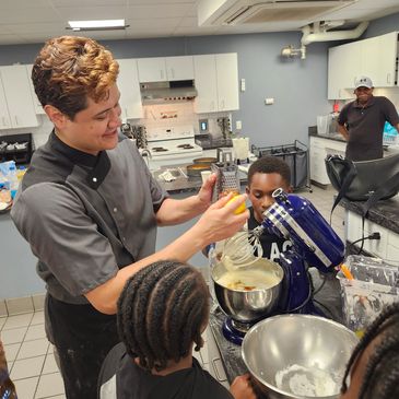 Our youth learning how to bake with Pastry Chef Cesar Cortez.