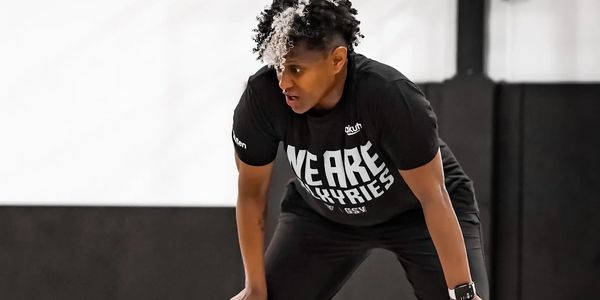 Person in a black shirt preparing to exercise.