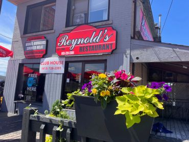 Reynold's Restaurant exterior with colorful flowers.
