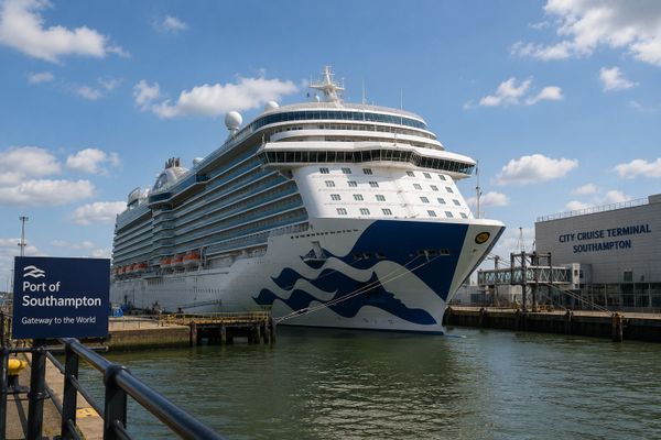 Large cruise ship docked at Port of Southampton on a sunny day.