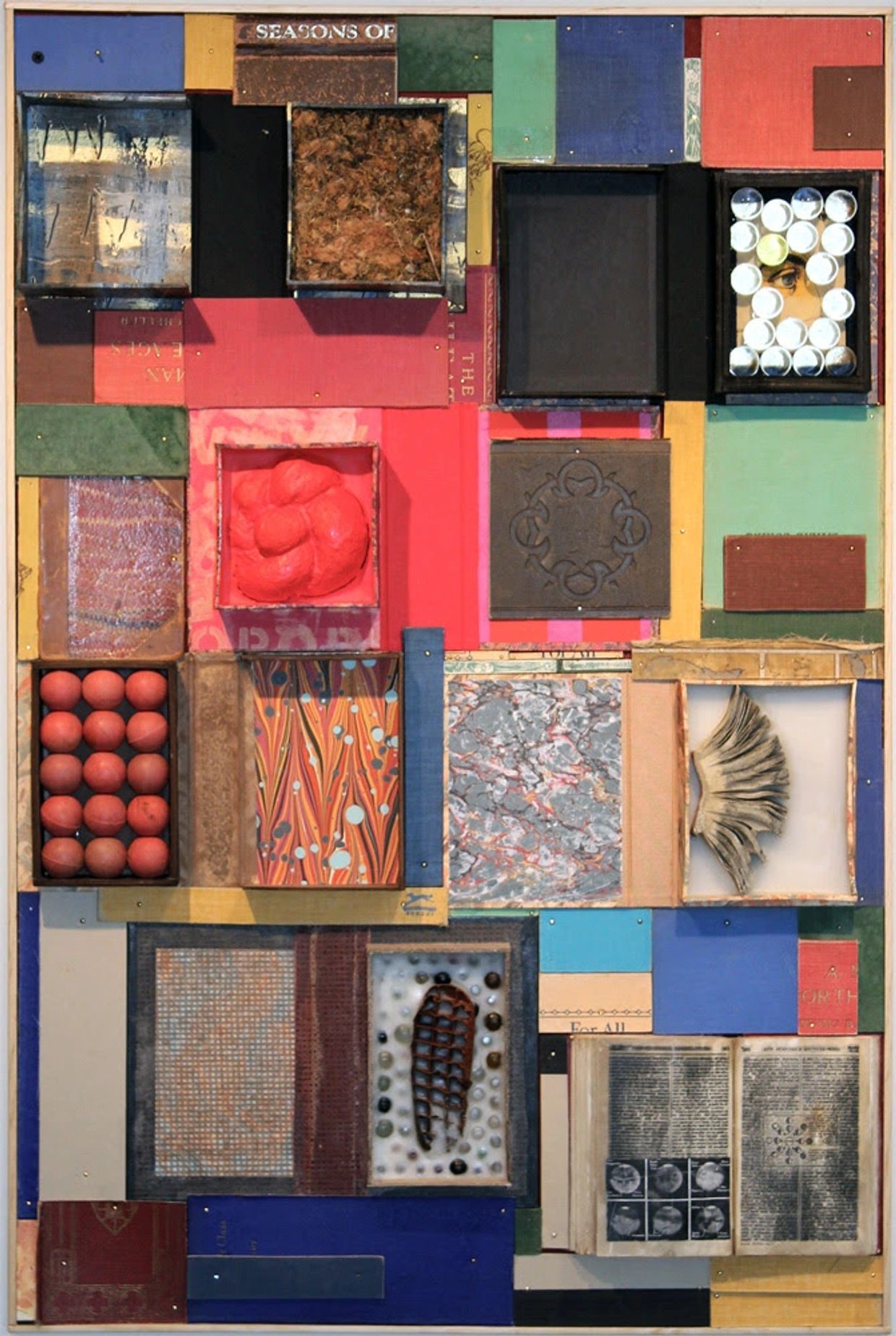 A colorful mixed-media collage with various textures and objects in square compartments.