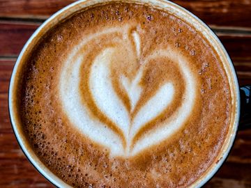 Close-up of a latte with heart-shaped foam art.