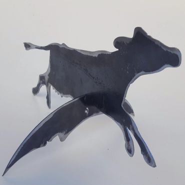 Black metal sculpture of a cow.