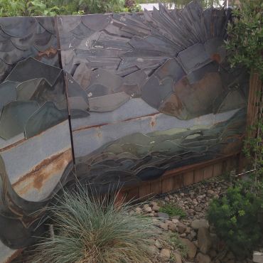 Abstract metal art panel with nature elements.