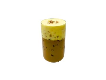 Iced coffee with creamy foam and a sprinkle of spice on top.
