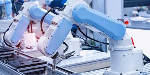 Blue robotic arms assembling components on a production line.