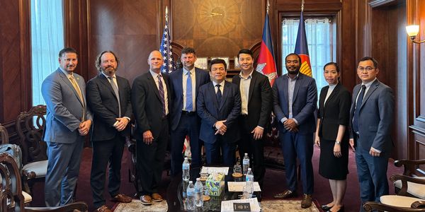 Group of professionals posing in a formal office setting.
