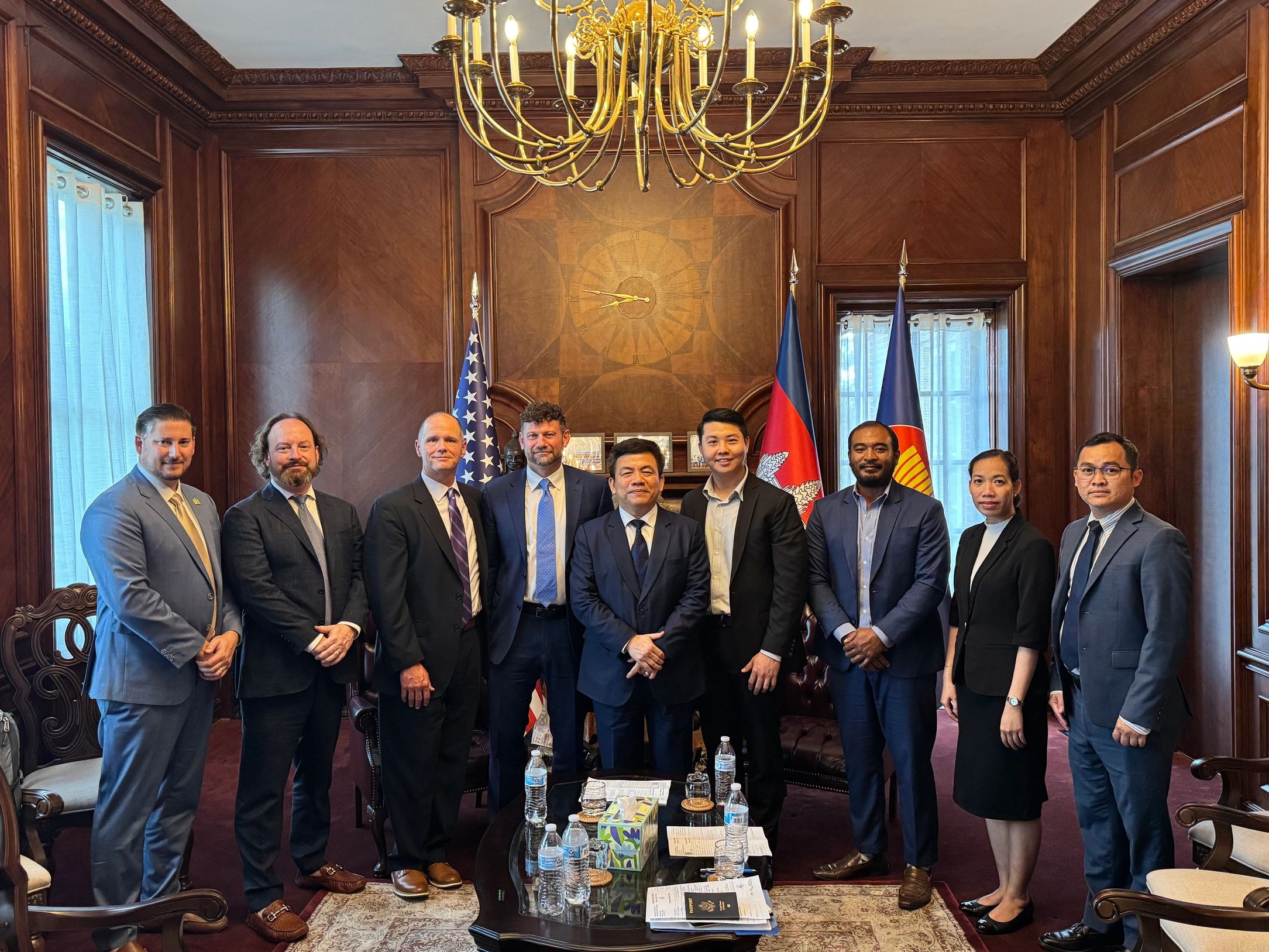 Group of formal professionals posing in an elegant office room.