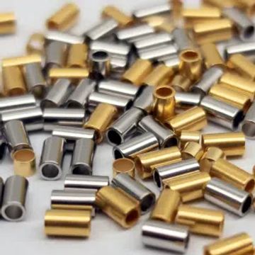 Small metallic gold and silver cylindrical beads scattered.