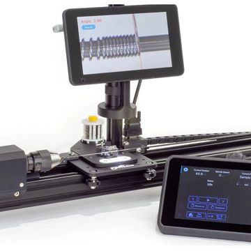 A precision coil winding machine with digital angle display and control panel.