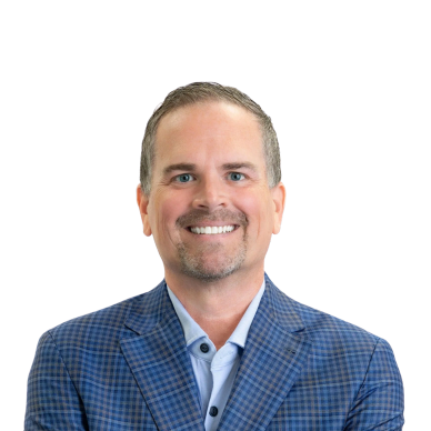 Smiling man in a blue checkered blazer and light blue shirt.