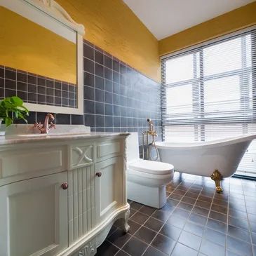 This stunning bathroom remodel features modern fixtures, sleek finishes, and elegant tile work.