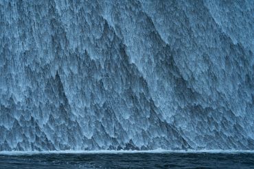 Close-up of cascading waterfall with turbulent water.