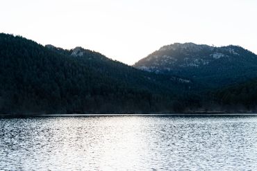 Lake with mountains in the background at sunset.