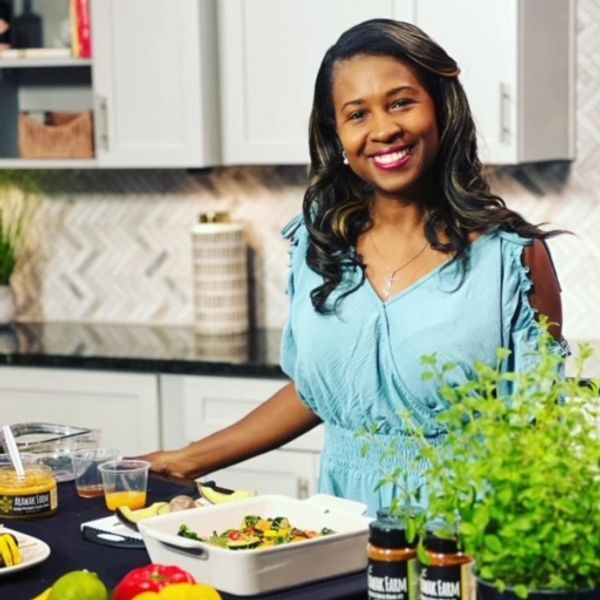 Founder of Cook Pray Slay standing at kitchen counter
