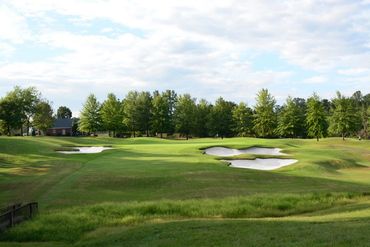 11th hole par 3, falls downhill steeply to a creek, before rising to the green surrounded by challen