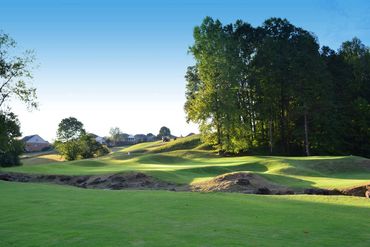 View of the 7th green as you approach from below the hole, from right side of fairway. Beware the cr