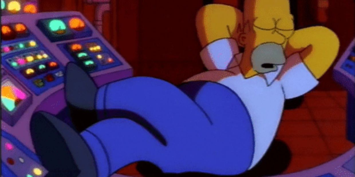 Homer Simpson sleeping at his work station with feet up.