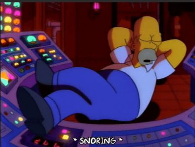 Homer Simpson sleeping at his work station with feet up.