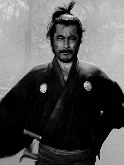 Black and white image of a serious samurai with traditional attire and swords.