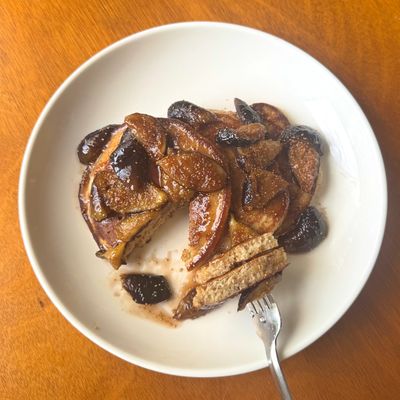 Sweet caramelized apple pancakes on a white plate.