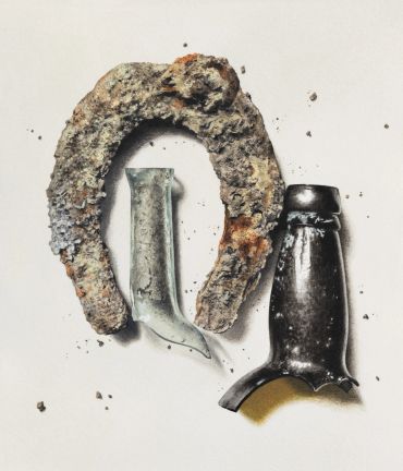 A rusty horseshoe, a glass bottle, and a capped bottle arranged artistically.