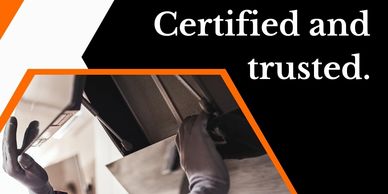 Certified and trusted technician inspecting a commercial kitchen hood and exhaust system