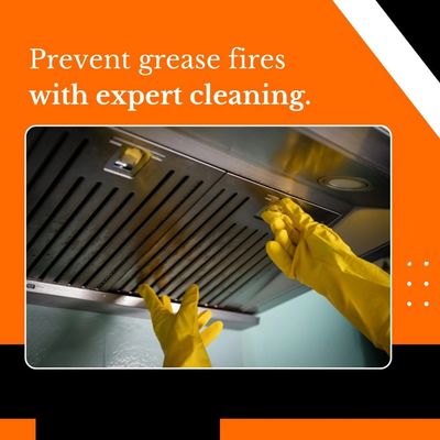 Gloved hands cleaning a kitchen hood to prevent grease fires.