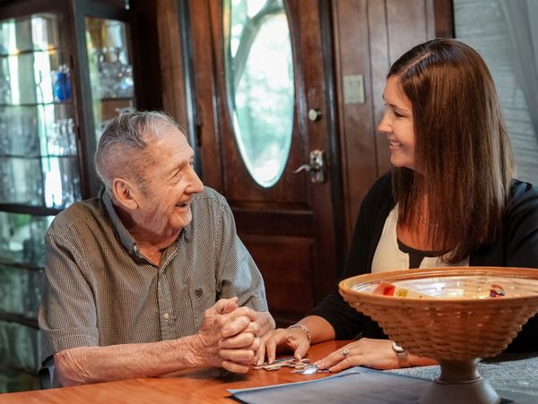 Trust in us caregiver building a puzzle with a patient in Skowhegan, Maine.