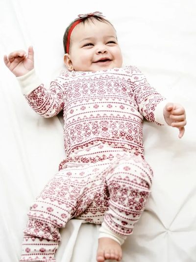 Smiling baby laying on bed