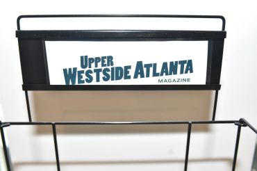 Magazine rack holding Upper Westside Atlanta Magazine.