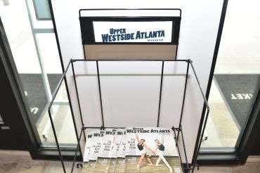 Magazine rack with Upper Westside Atlanta magazines.
