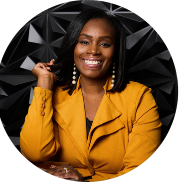 Confident woman in a mustard yellow blazer smiling against a geometric black background.