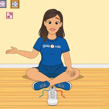 Girl sitting cross-legged with a sneaker in front.