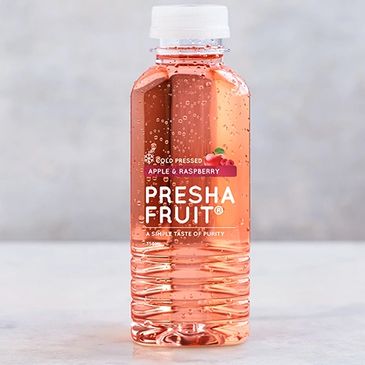 A clear plastic bottle of Presha Fruit apple and raspberry juice with bubbles.