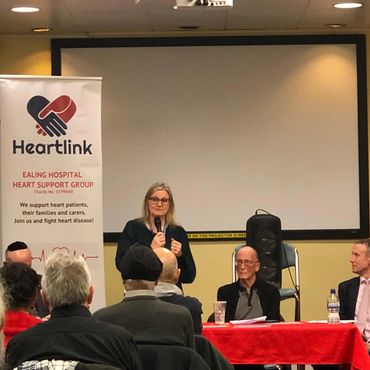 A woman speaks at a Heartlink event supporting heart patients and families.