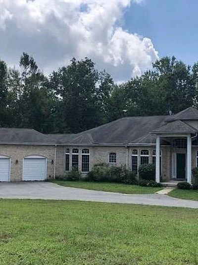 Single-story house with two garages and large windows.