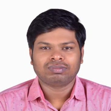 Dr. Vignesh Subramaniyan, surgical oncologist, in pink shirt, smiling.