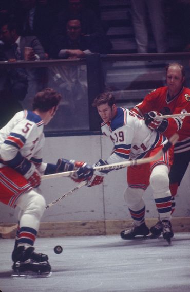 Bobby Hull battles Jean Ratelle.