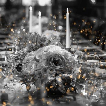 Elegant black-and-white table setting with flowers and candles.