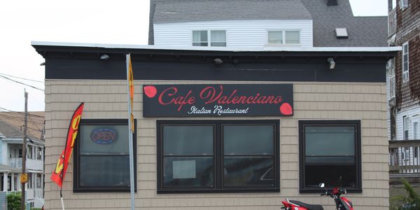 A scenic view of mountains with a clear blue sky and a tranquil lake reflecting the landscape.