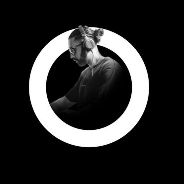 DJ wearing headphones focused inside a glowing circular frame on black background.