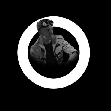 Black and white portrait of a man with goggles and a cigarette inside a white circular frame.