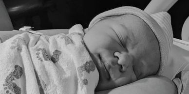 Sleeping newborn baby wrapped in a blanket.