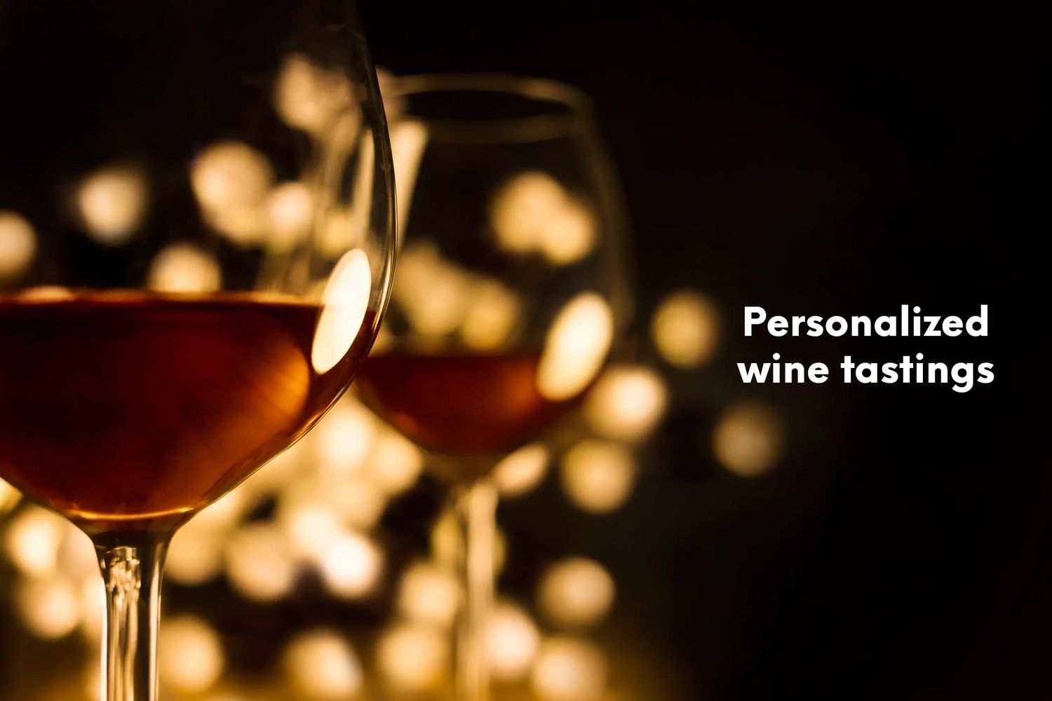 Two red wine glasses with white lights in the background and the words personalized wine tastings