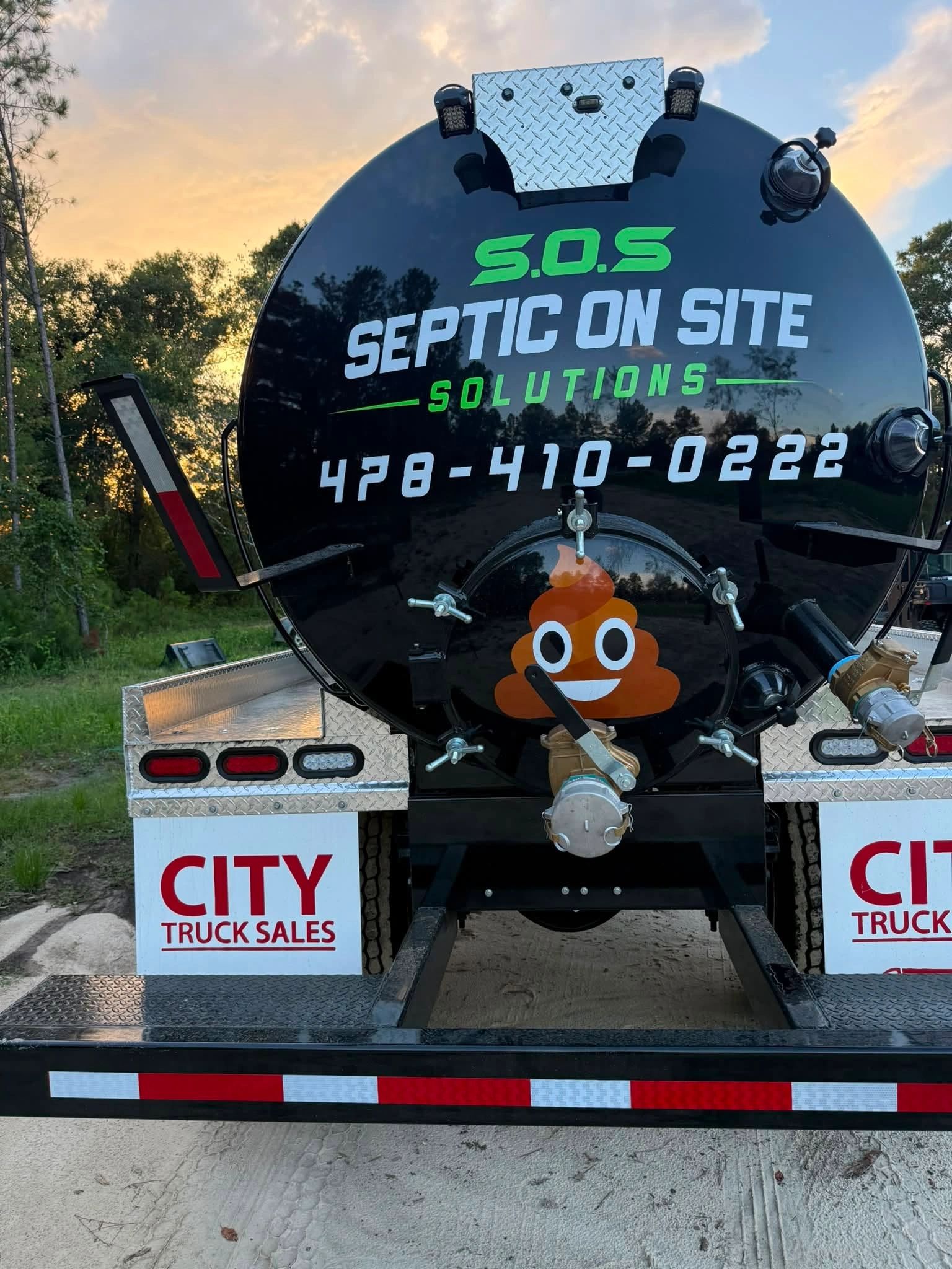 Septic service truck with contact details and poop emoji.