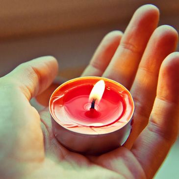 Hand holding small candle