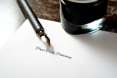 Quill, Ink and Pad with Paper Trails Publishing Written on the Pad
