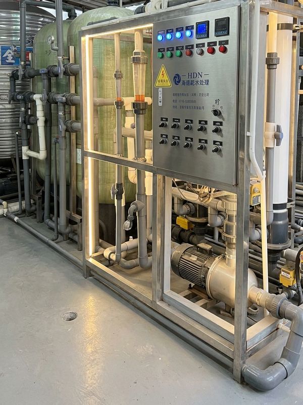 Industrial water treatment system with control panel and pipes.